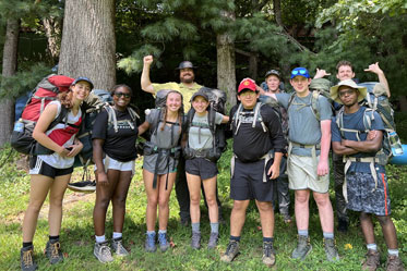 Students posing for the camera after a long hike. Links to Gifts from Retirement Plans