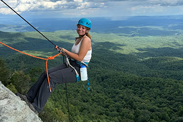 A woman rock climbing. Links to Under Age 45