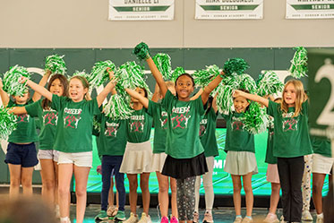 The cheer team performing their routine together. Links to Tangible Personal Property